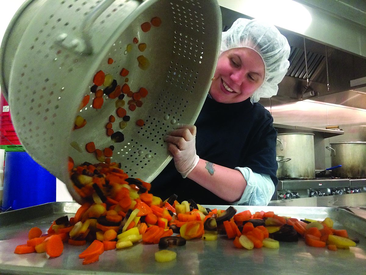 food worker processing carrots