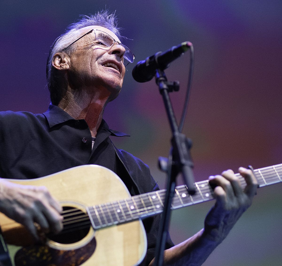 man playing the guitar and singing