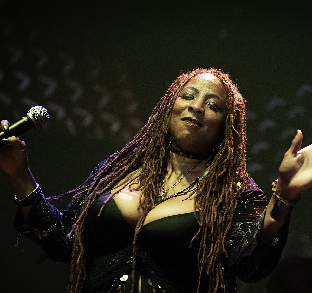 woman with microphone dancing and singing