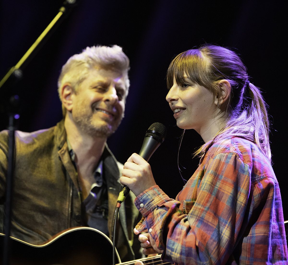 man and woman singing together